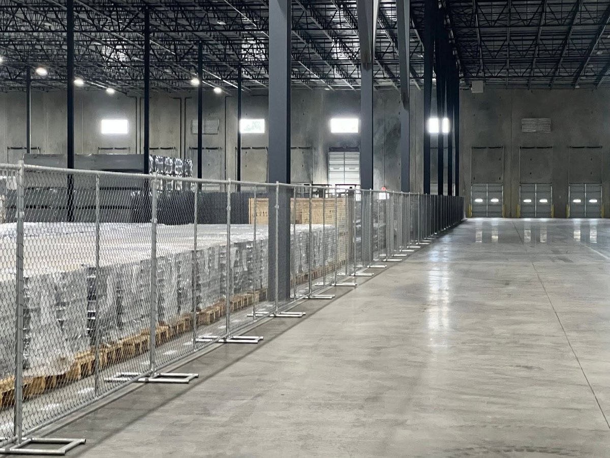 Chain-link fencing installed inside a large commercial warehouse in Brookshire TX