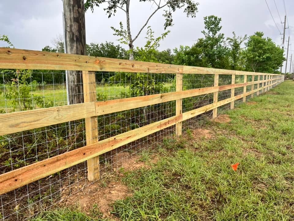 Wooden ranch rail fence with wire mesh installed along a rural Brookshire TX property